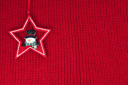 Christmas decoration over red wool fabric backgroundの写真素材