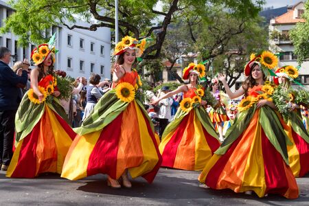 FUNCHAL, MADEIRA - APRIL 20, 2015: Dancers perform during of Flower parade at the Madeira Island, Portugalのeditorial素材