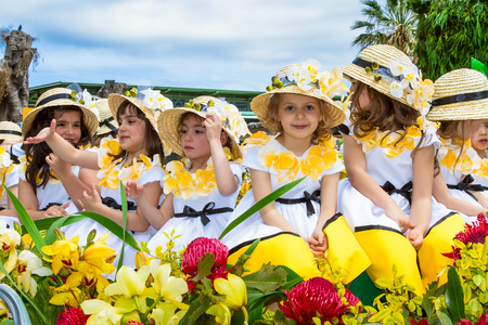 FUNCHAL, MADEIRA, PORTUGAL - APRIL 19, 2015: Children in floral costumes at the Flower Festival Parade, Funchal, Madeira, Portugalのeditorial素材