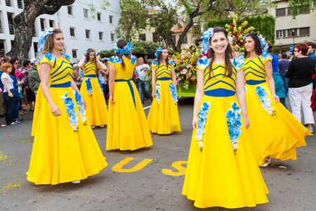 FUNCHAL, MADEIRA, PORTUGAL - APRIL 19, 2015: Participants of the Flower Festival, Madeira's cultural tradition of street dancing and merry making in Funchal City, Madeira, Portugal.のeditorial素材