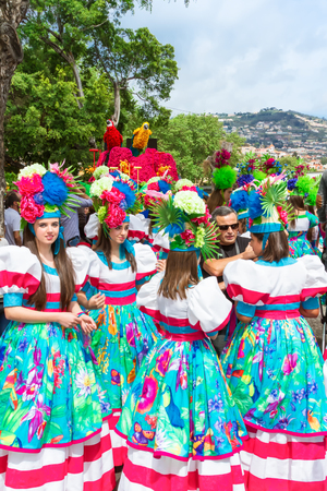 FUNCHAL, MADEIRA, PORTUGAL - APRIL 19, 2015: Performers with colourful  costumes taking part in the Parade of Flower Festival on the Madeira Island, Portugal.のeditorial素材