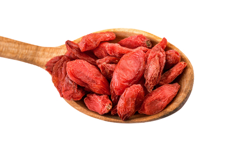 Goji berry. Dried goji berries on a wooden spoon isolated on white with clipping pathの写真素材