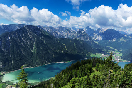 Aerial view of blue mountain lake between forested rocky mountains. Achensee, Austria, Tyrolの写真素材