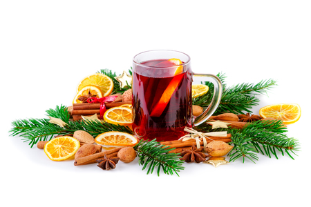 Mulled wine with christmas spices and fir branch on whiteの写真素材