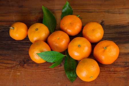 tangerines mandarin fruit top view over wooden background の写真素材