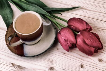Cup of coffee with tulips.Vintage still lifeの写真素材