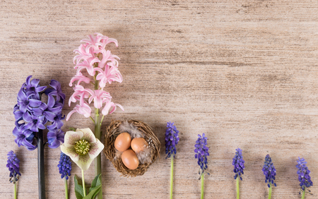 Easter retro background with hyacinth flowers in a row on light brown stoneの写真素材