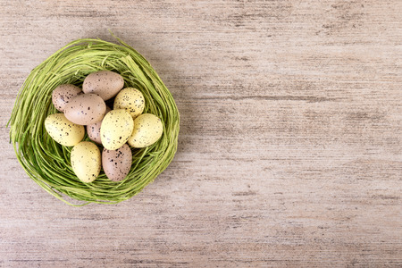 Easter eggs in green nest top view.  Vintage Easter decoration pastel colorsの写真素材