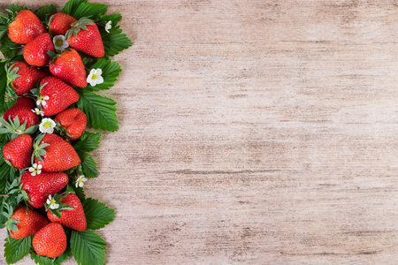 Strawberries decorative arrangement on light brown background. Top view, copy spaceの写真素材