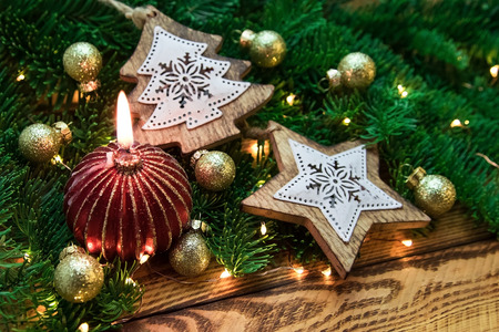 Christmas vintage decoration with fir branch and red candle in close-up