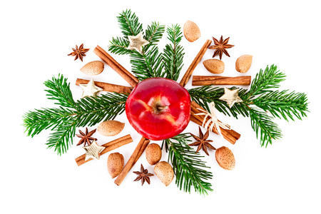 Christmas composition with fir branch and spicesand red apple isolated on whiteの写真素材