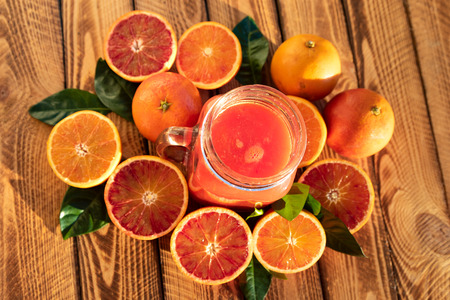 Orange juice of fresh blood oranges. Top view, outdoor shot in the sunshineの写真素材