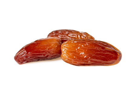 Sweet dates fruit or three dried dates isolated on white backgroundの写真素材