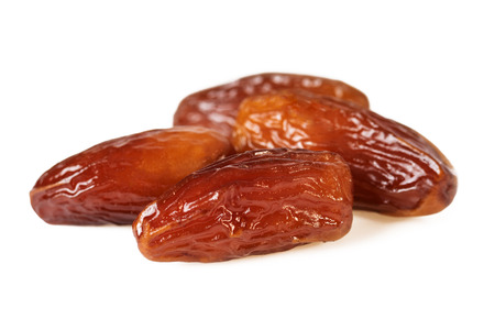 Sweet dates fruit or four dried dates isolated on white backgroundの写真素材