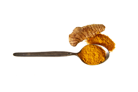 turmeric powder in spoon and fresh turmeric root isolated on white top viewの写真素材
