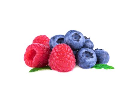 Raspberries with blueberries and mint leaves isolated on white backgroundの写真素材