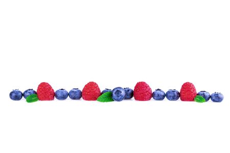 Raspberries and Blueberries in a line isolated on white. Fresh berry mix concept.の写真素材