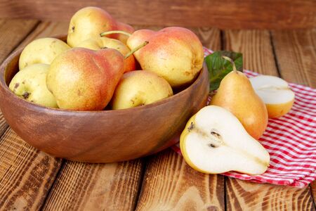 Autumn still life. Pears on old wooden table with red checkered tablecloth. Rustic design.の写真素材