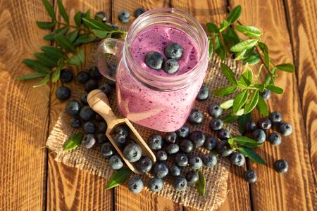 Blueberry dessert or blueberries smoothie with fresh berry on wooden background. Top view.の写真素材
