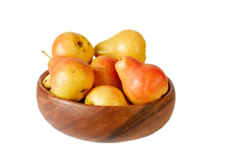 Pear in wooden bowl on white. Organic pear fruits isolated on white background.の写真素材