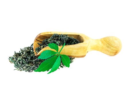 Jiaogulan Miracle Grass Leaf Chinese Herb Tea in Wooden Spoon On Whiteの写真素材
