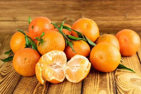 ripe tangerine mandarin fruits on old wooden backgroundの写真素材