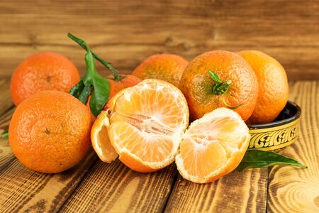 tangerine or mandarin fruits in close up on old wooden backgroundの写真素材