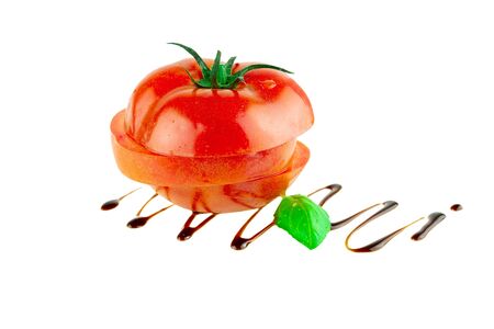 Italian cuisine tomato with basil and balsamic vinegar isolated on whiteの写真素材