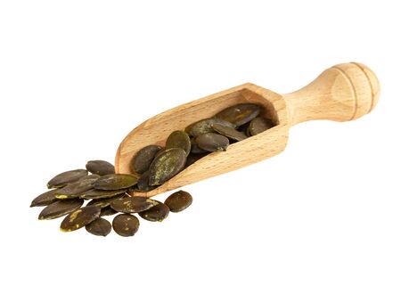 Serving scoop with pumpkin seeds isolated on whiteの写真素材