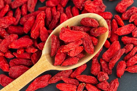 Goji berries in wooden spoon.の写真素材