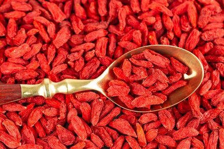 Goji berries in a gold vintage spoon, view from above.の写真素材