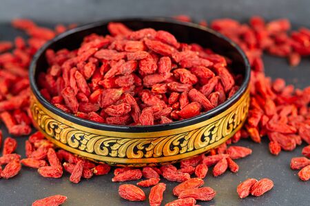 Goji berry in east oriental cup in closeup. Selective focusの写真素材