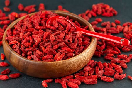 Close Up Of Dried Goji Berries In Wooden Cup. Selective Focusの写真素材