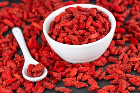 Red Organic Goji Berries In White Cup. Selective Focusの写真素材