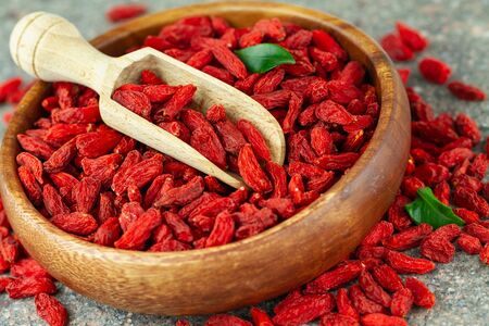 Close up of dried goji berries in wooden bowl.の写真素材