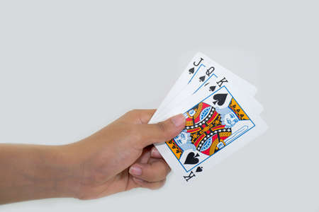 Playing cards in hand isolated on white backgroundのeditorial素材