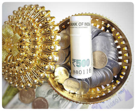 Indian new currency spread randomly with coins in golden color gift box beautifully and 500 rupees...