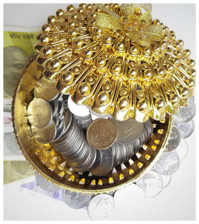 Indian new currency spread randomly with coins in golden color gift box beautifully and 500 rupees with rubber bandの写真素材