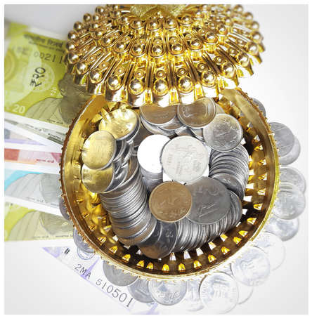 Indian new currency spread randomly with coins in golden color gift box beautifully and 500 rupees with rubber bandの写真素材