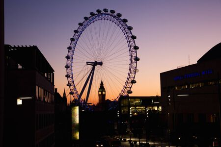 London, UK - January 21, 2011: London Eye and Westminster in the distance seen from Waterloo Bridge at dusk.のeditorial素材