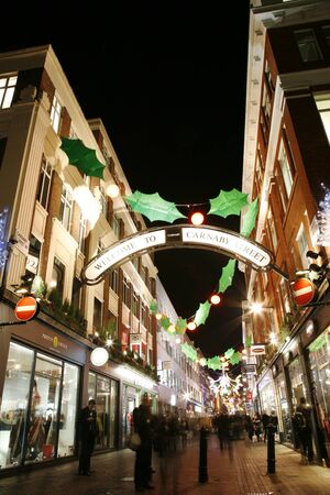 London, UK - November 17, 2011: Christmas Lights Display on Carnaby Street in London. The modern colourful Christmas lights attract and encourage people to the streetのeditorial素材