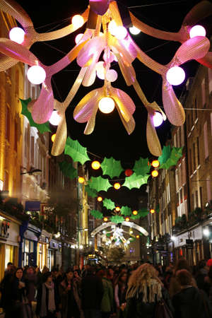 London, UK - November 17, 2011: Christmas Lights Display on Carnaby Street in London. The modern colourful Christmas lights attract and encourage people to the streetのeditorial素材