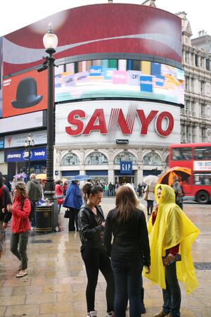 London, UK - August 13, 2010: Tourists in Piccadilly Circus, famous tourist attraction, road junction, built in 1819, meeting place, tourist attraction, in West End, inks to Shaftesbury Avenue, Regent Street, Haymarket, Leicester Square and Glasshouse Strのeditorial素材