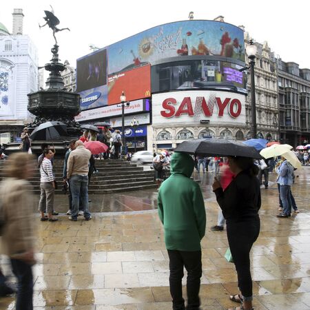 London, UK - August 13, 2010: Tourists in Piccadilly Circus, famous tourist attraction, road junction, built in 1819, meeting place, tourist attraction, in West End, inks to Shaftesbury Avenue, Regent Street, Haymarket, Leicester Square and Glasshouse Strのeditorial素材