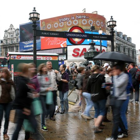 London, UK - August 13, 2010: Tourists in Piccadilly Circus, famous tourist attraction, road junction, built in 1819, meeting place, tourist attraction, in West End, inks to Shaftesbury Avenue, Regent Street, Haymarket, Leicester Square and Glasshouse Strのeditorial素材