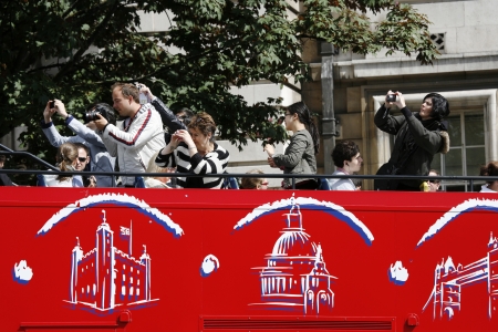 London, UK - June 17, 2012: London Sightseeing bus. Tourists love the open-top tour bus enable them, a great way to travel around the capital, see the major sights. London attracts 30 million international visitors per year. のeditorial素材
