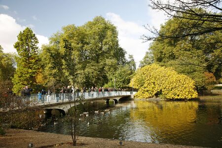 London, UK - October 29, 2012: People enjoy autumn color on bright sunny day at St James's Park, bounded by Buckingham Palace, oldest royal parks in London, 
のeditorial素材