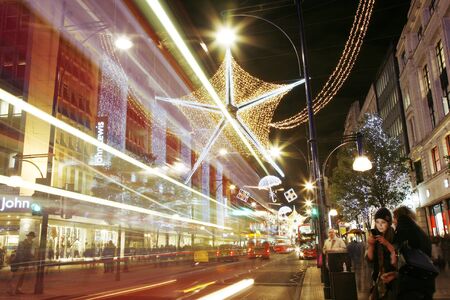 London, UK - November 18, 2011: Christmas Lights Display on Oxford Street in London. The modern colourful Christmas lights attract and encourage people to the street. のeditorial素材