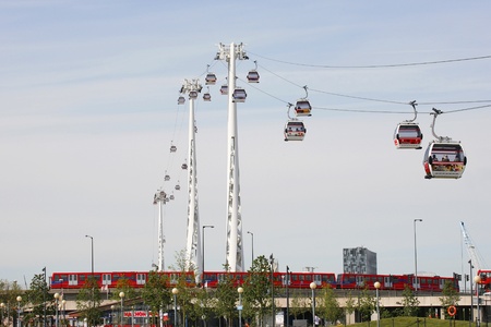 London , UK - May 26, 2013:  Gondolas of the Emirates Air Line cable car, opened June 2012, run by TFL, links the Greenwich Peninsula with Royal Dock, 1km, across the River Thames and the DLR, Docklands Light Railway, present.   
のeditorial素材