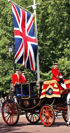 London, UK - June 15, 2013: Queen Elizabeth II seat on the Royal Coach at Queen's Birthday Parade, union jack and coach man present. Queen's Birthday Parade take place to Celebrate Queen's Official Birthday in every June in London. 
のeditorial素材
